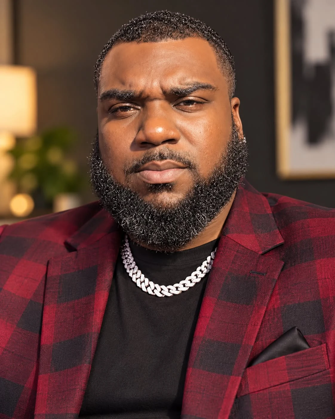 Tyree Baker, known as Musa, in a burgundy and black blazer.